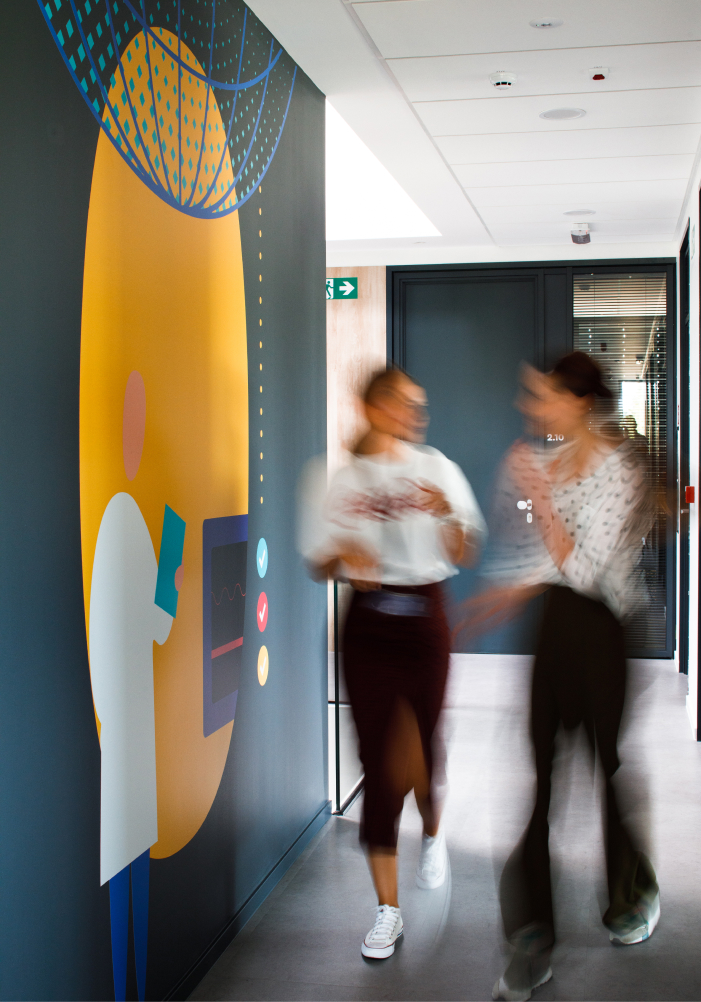 Two project managers walking inside the Mono building